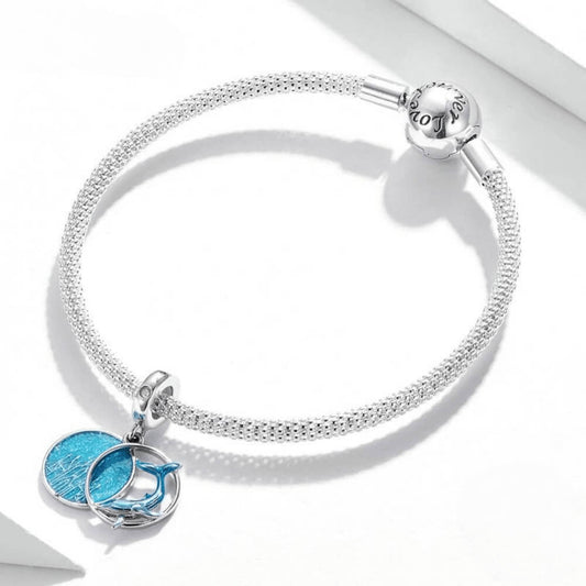 Sterling silver double dangle charm with blue whale design and glittery round disc.