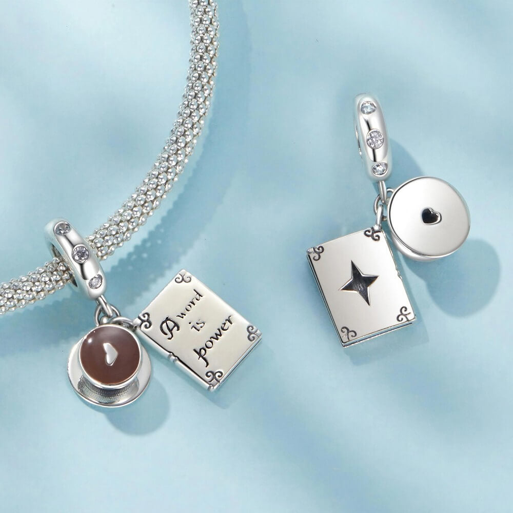 Sterling silver book and coffee charm with engraved inspirational quote.