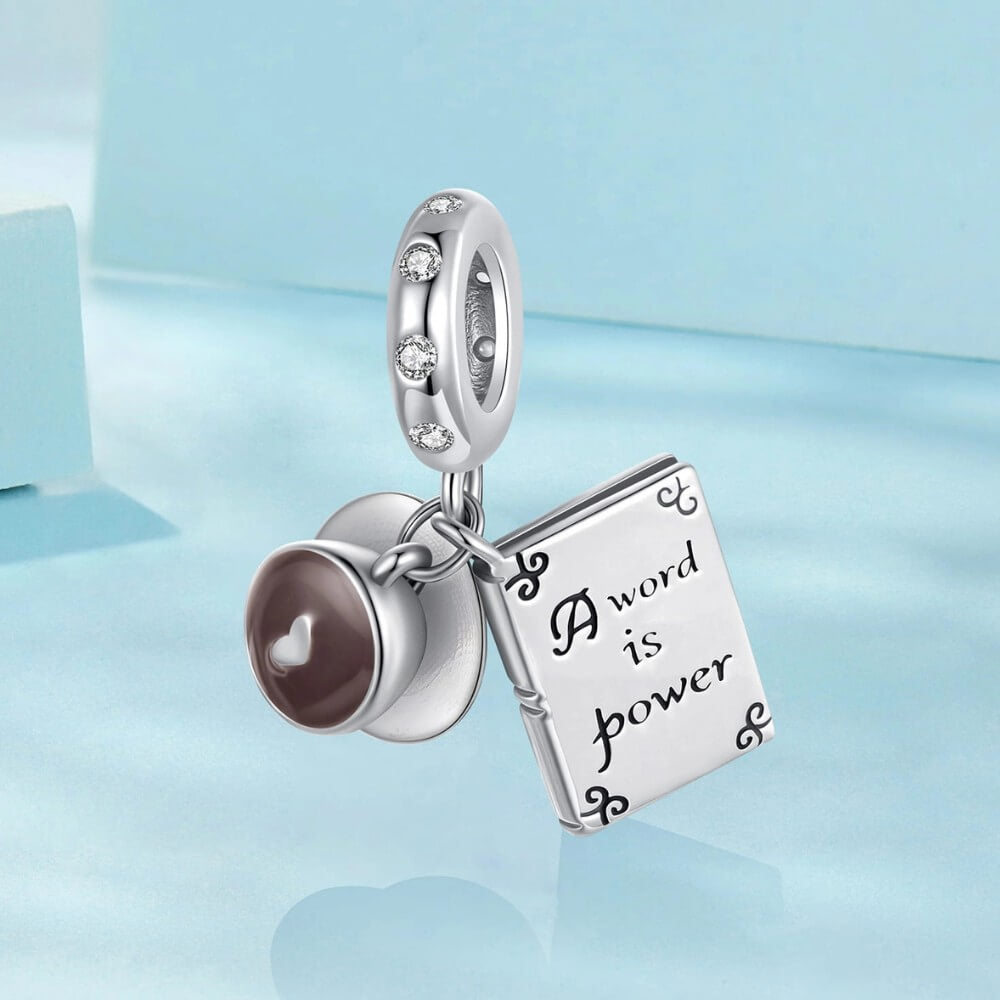 Sterling silver book and coffee charm with engraved inspirational quote.