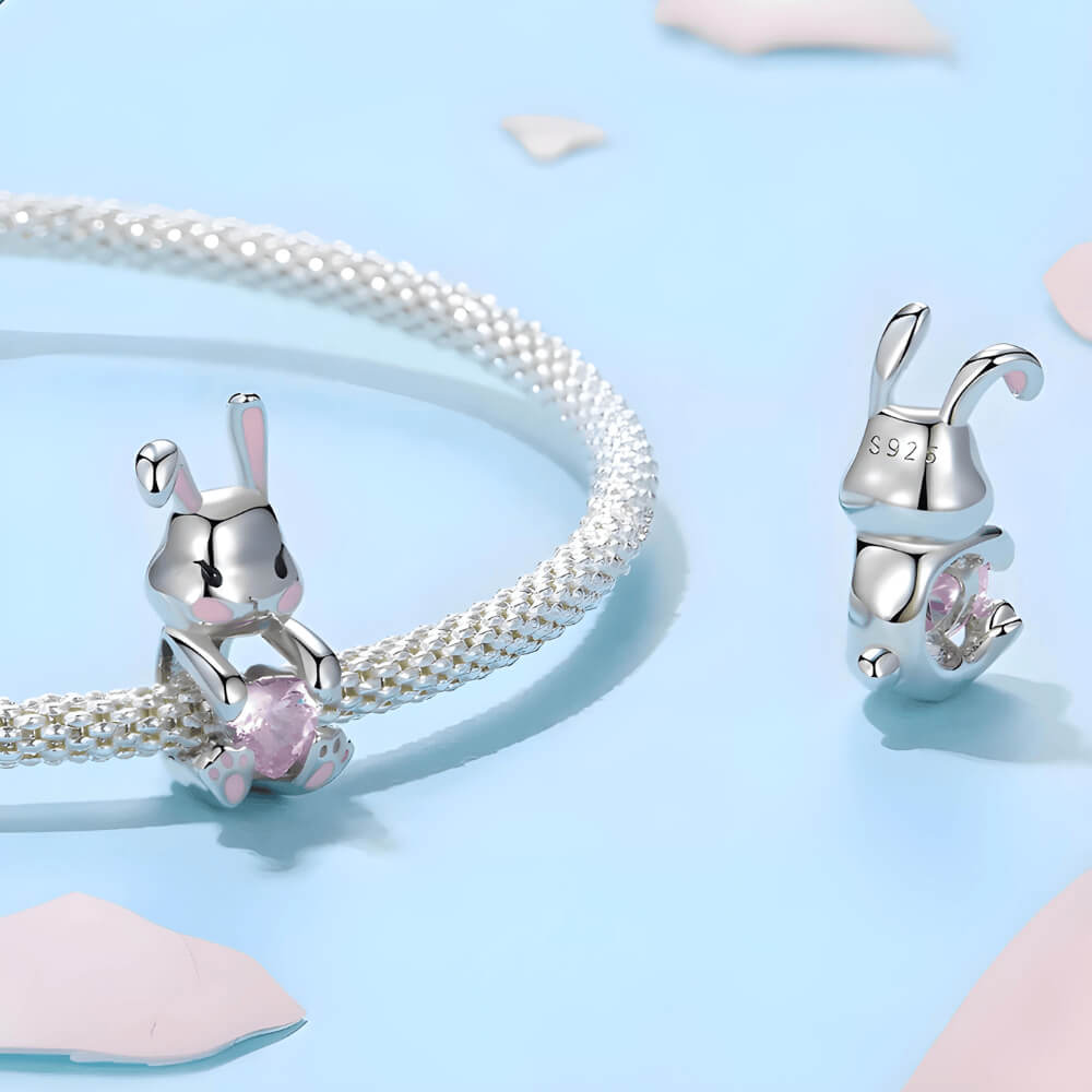 Sterling silver bunny charm with pink enamel accents and pink heart-shaped crystal 