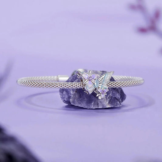 Sterling silver butterfly charm with pastel enamel flowers and crystal center.