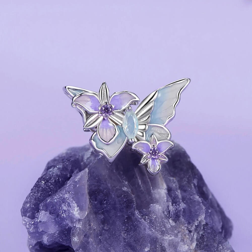 Sterling silver butterfly charm with pastel enamel flowers and crystal center.