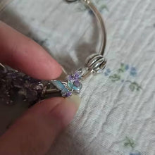 Sterling silver butterfly charm with pastel enamel flowers and crystal center.