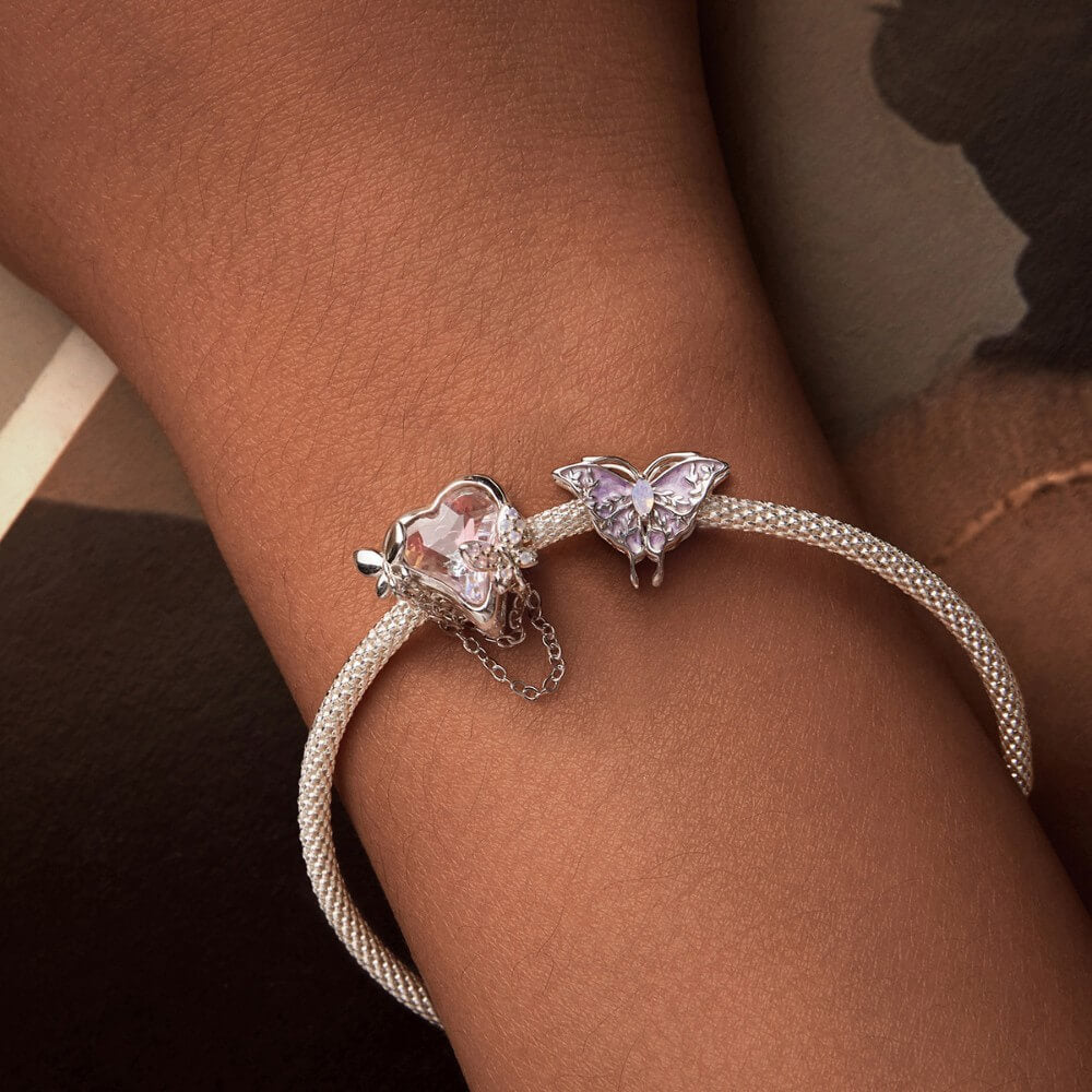 Sterling silver butterfly charm with pink enamel and crystal accents.