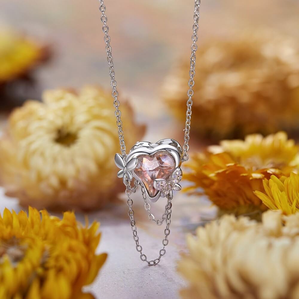 Sterling silver butterfly charm with pink enamel and crystal accents.