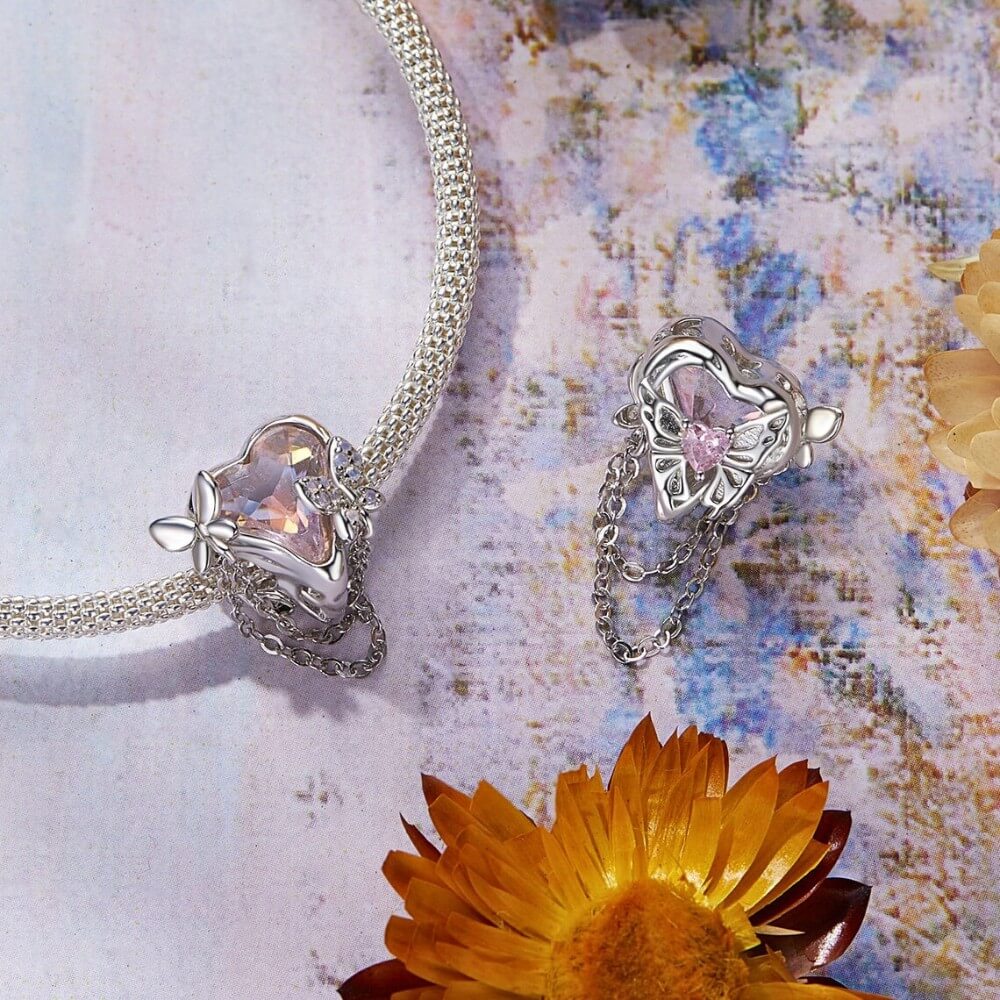 Sterling silver butterfly charm with pink enamel and crystal accents.