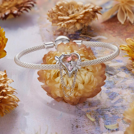 Sterling silver butterfly charm with pink enamel and crystal accents.