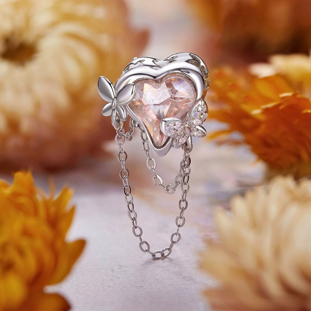 Sterling silver butterfly charm with pink enamel and crystal accents.