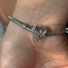 Sterling silver butterfly charm with pink enamel and crystal accents.