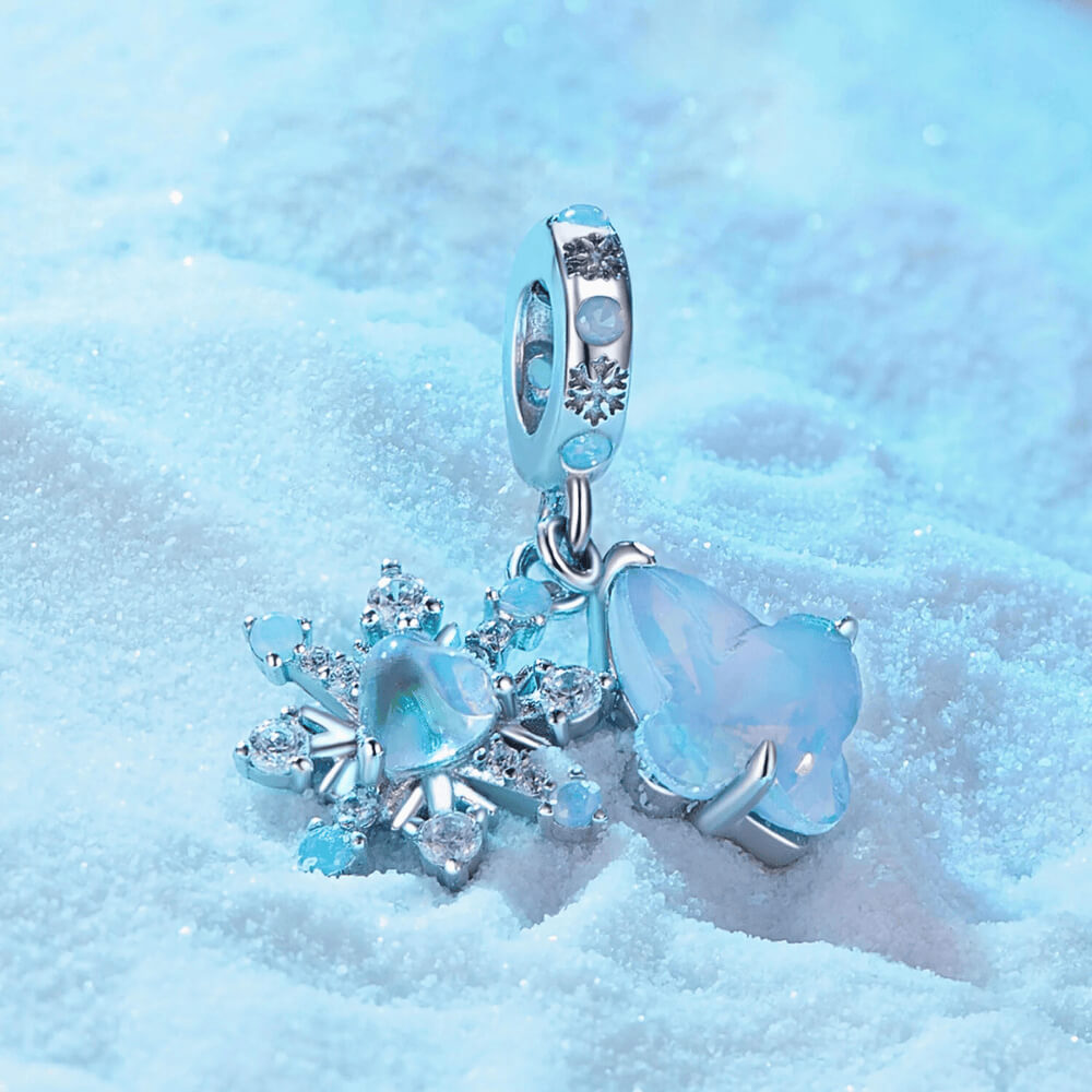 Sterling silver double dangle charm with opal-like butterfly, snowflake, and light blue accents.