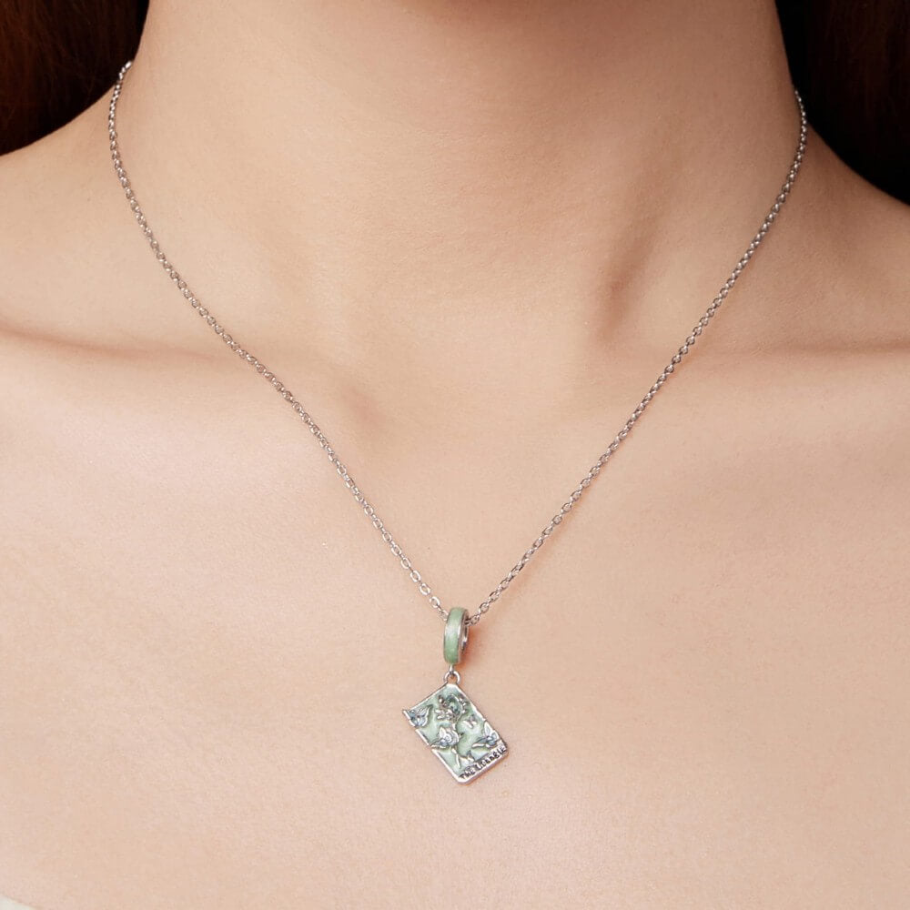 Sterling silver tarot card charm with butterflies, green enamel, and crystal rose.