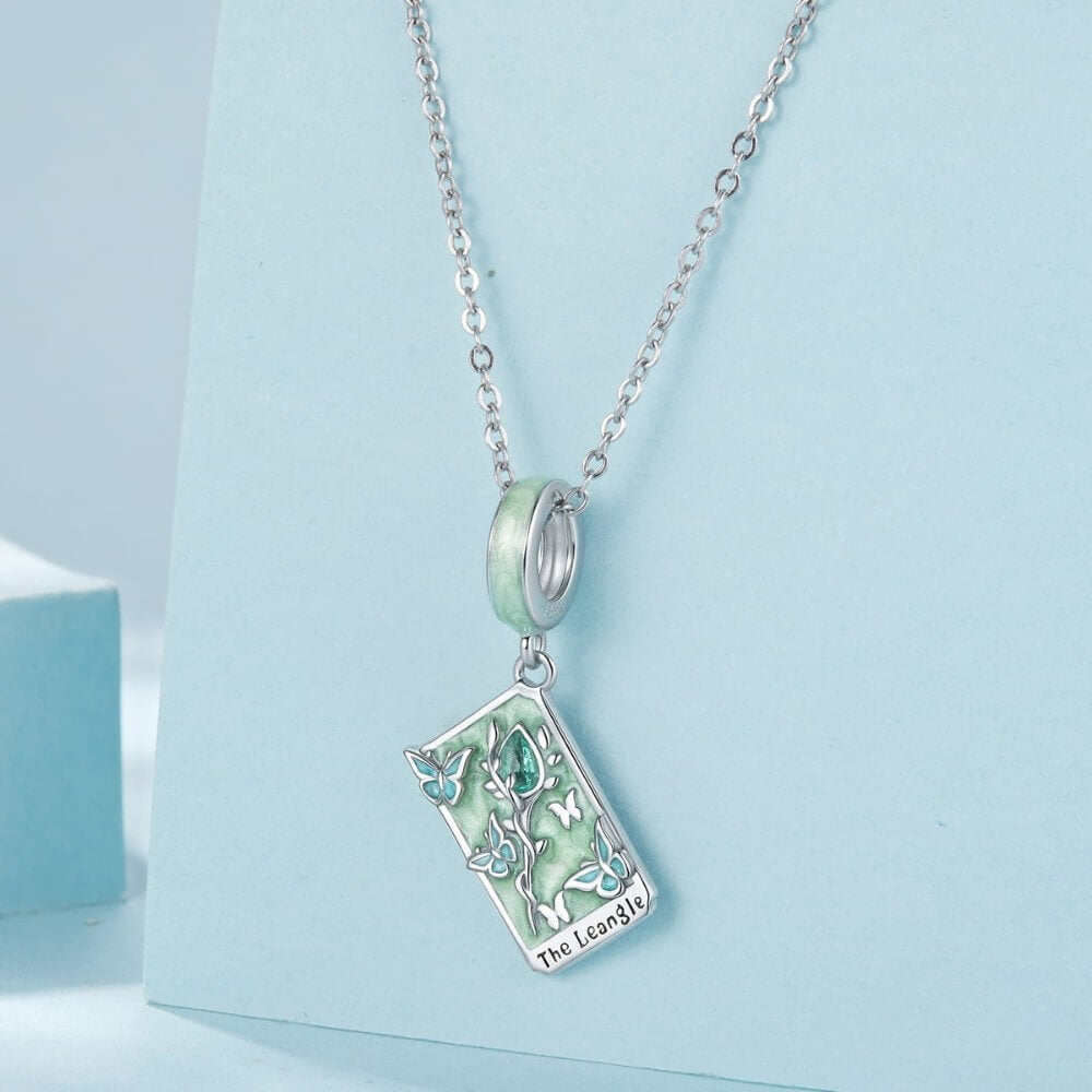 Sterling silver tarot card charm with butterflies, green enamel, and crystal rose.