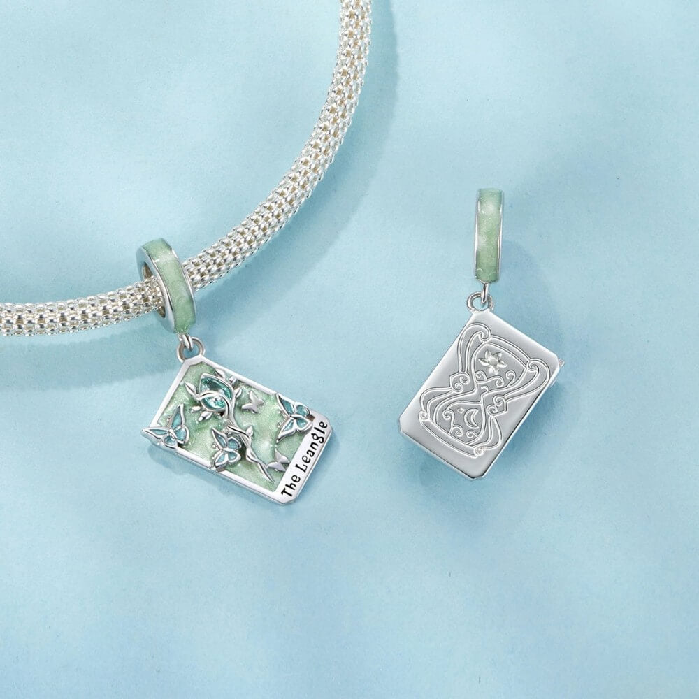 Sterling silver tarot card charm with butterflies, green enamel, and crystal rose.