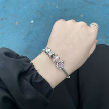 Sterling silver castle charm with pink heart center and crystal border.