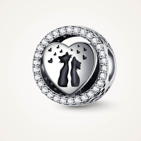 Sterling silver cat heart charm with crystal border and black silhouettes.
