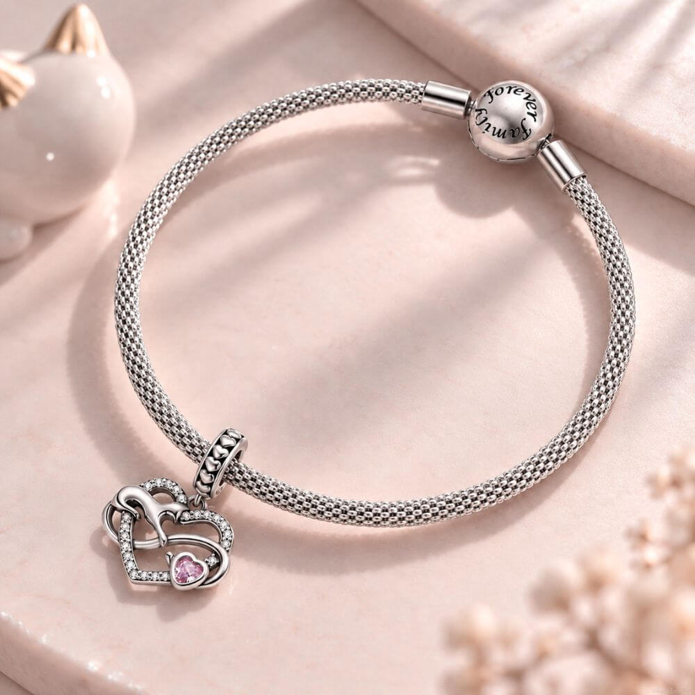 Sterling silver cat heart charm with infinity design, sparkling crystals, and a pink heart stone accent.