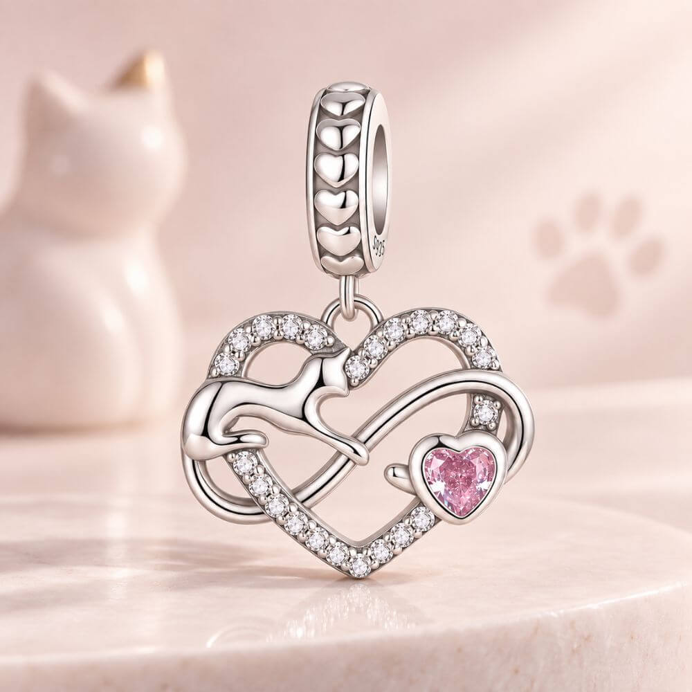 Sterling silver cat heart charm with infinity design, sparkling crystals, and a pink heart stone accent.