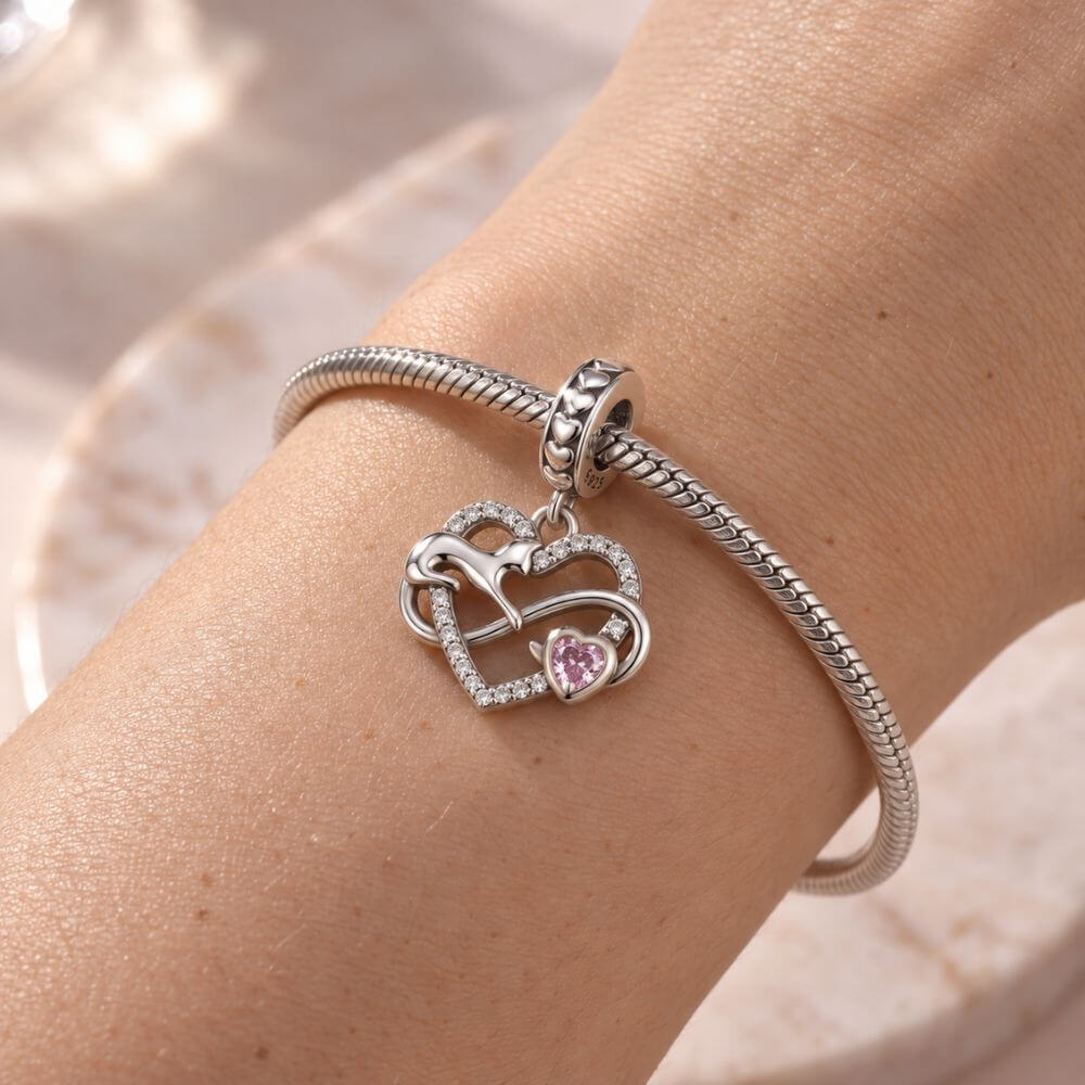 Sterling silver cat heart charm with infinity design, sparkling crystals, and a pink heart stone accent.
