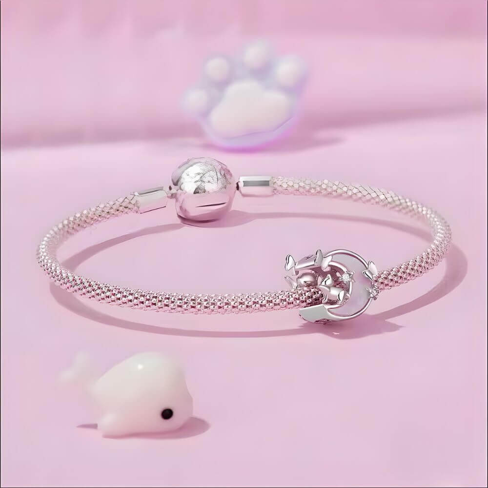 Sterling silver cat and moon charm with pink opal-like inlay and clear stones.