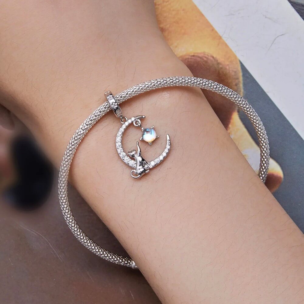 Sterling silver cat moon charm with star and opal crystal.