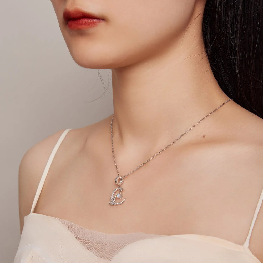 Sterling silver cat moon charm with star and opal crystal.
