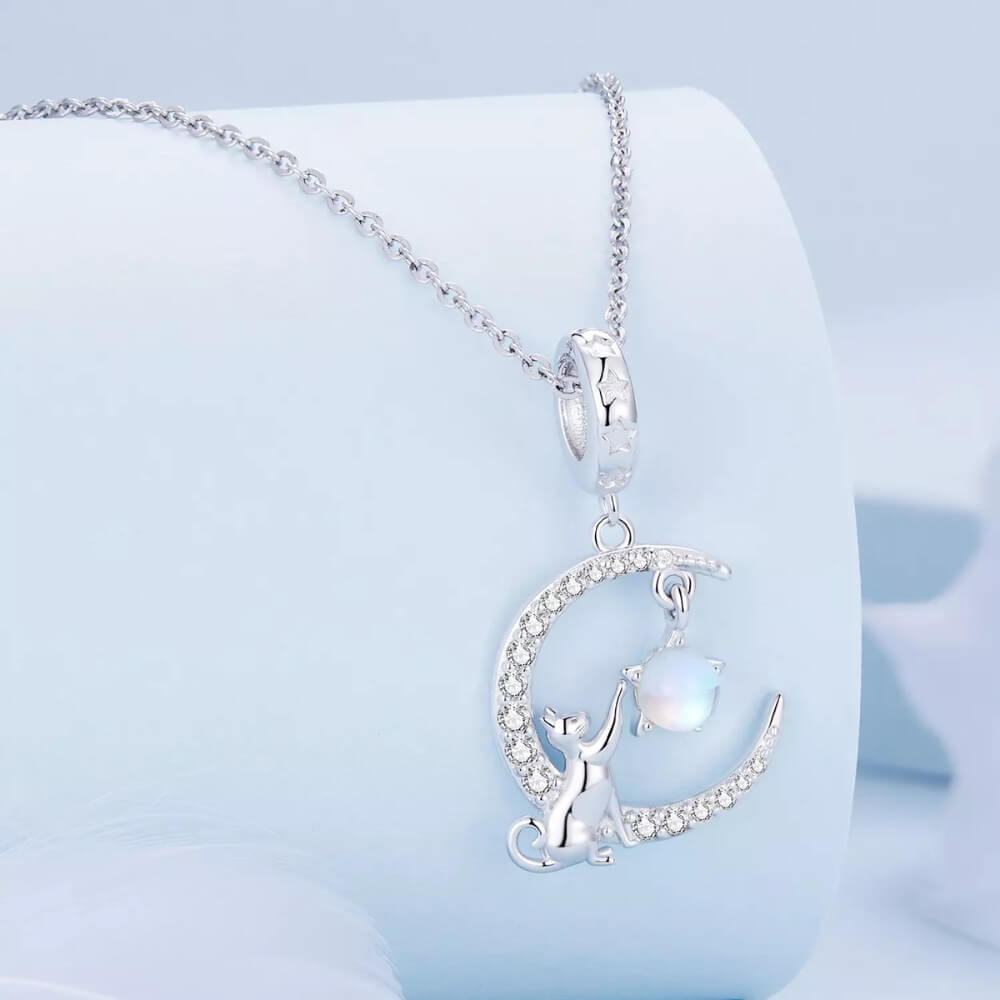 Sterling silver cat moon charm with star and opal crystal.