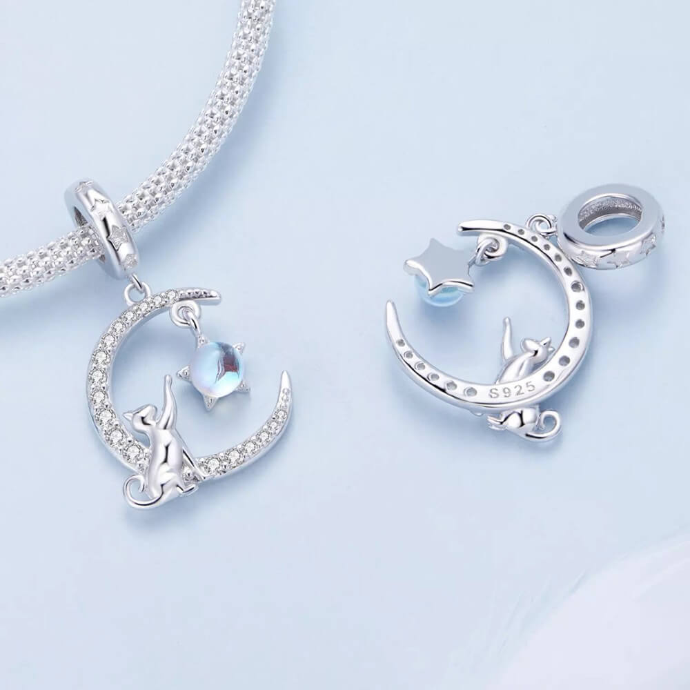 Sterling silver cat moon charm with star and opal crystal.