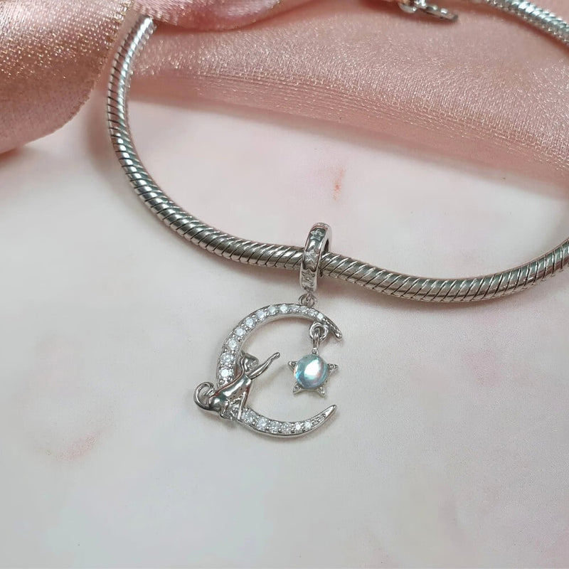 Sterling silver cat moon charm with star and opal crystal.