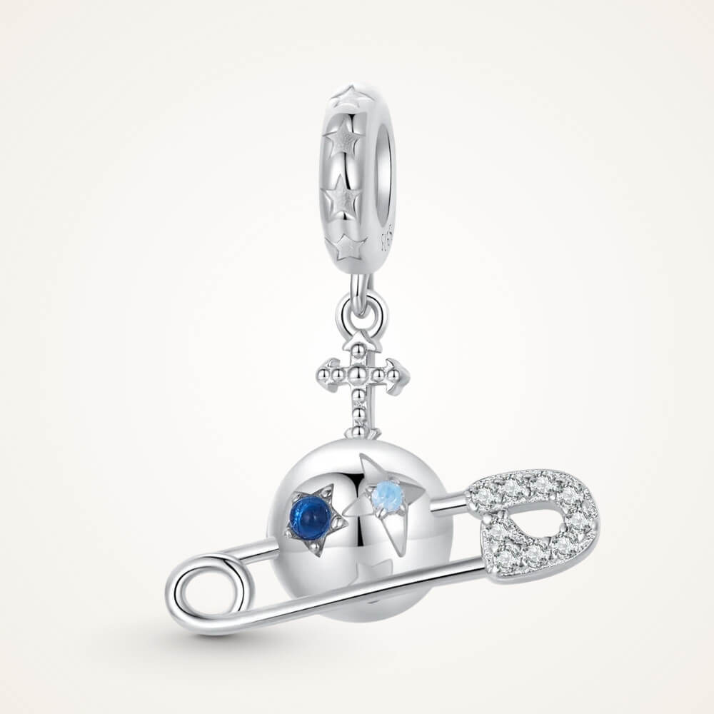 Sterling silver safety pin charm with stars, crystals, and celestial details.