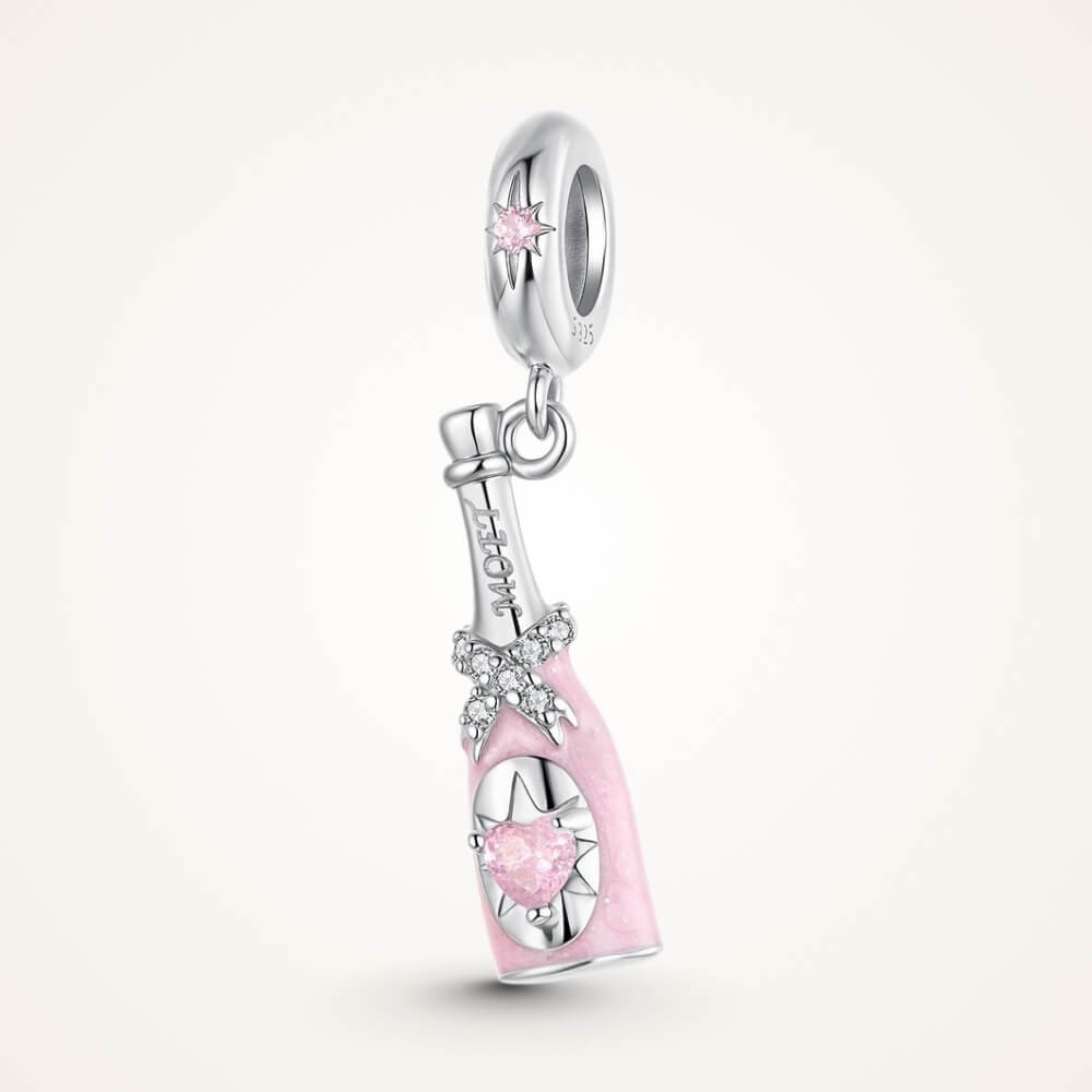 Sterling silver champagne bottle charm with pink enamel, bow detail and heart crystal - ORÉYA