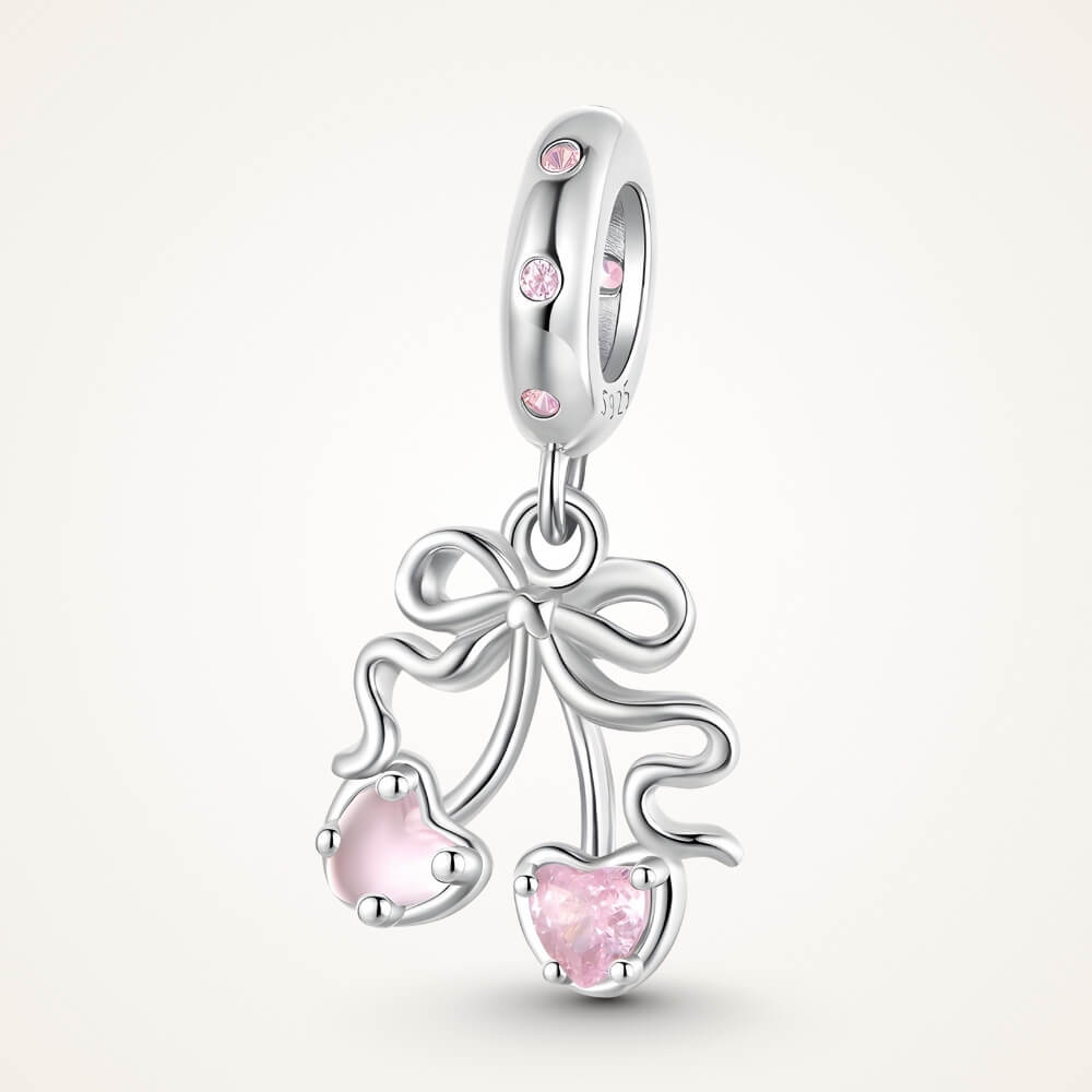 Sterling silver cherry charm with pink heart gemstones and bow detail - ORÉYA