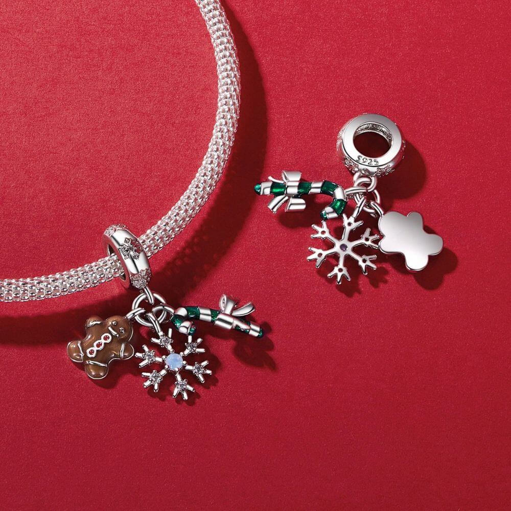 Sterling silver Christmas charm with gingerbread man, candy cane, bow, snowflake, and sparkling crystal details.