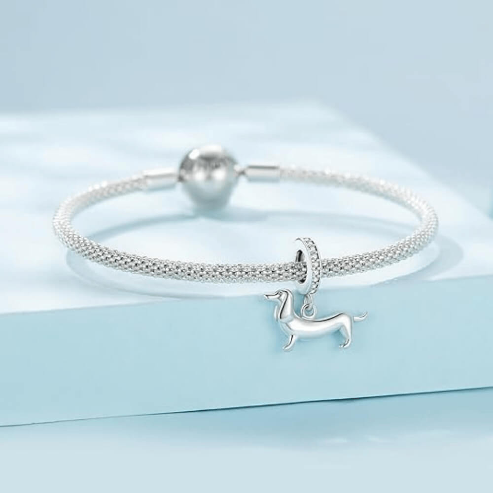Sterling silver dachshund charm with long body and crystal-studded bail 