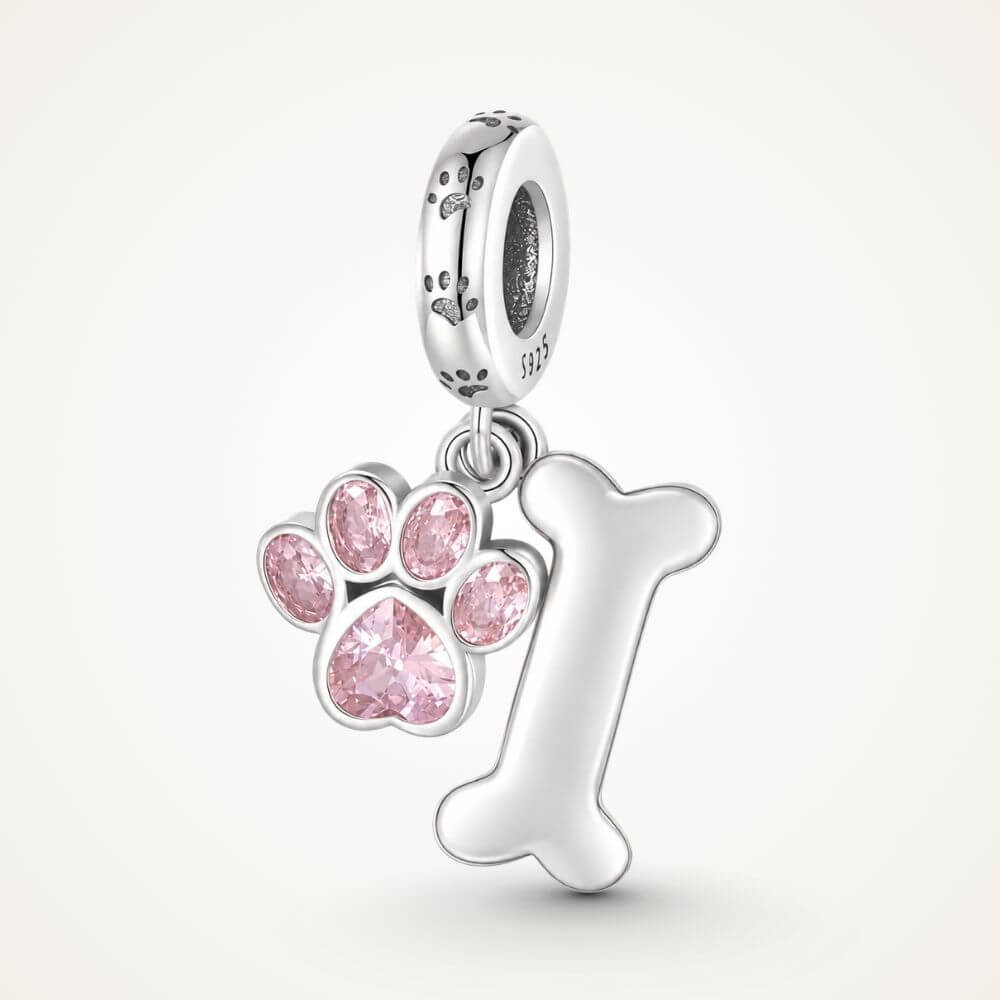 Sterling silver dog paw charm with pink crystal paw print, bone dangle, and playful pet-inspired details - ORÉYA