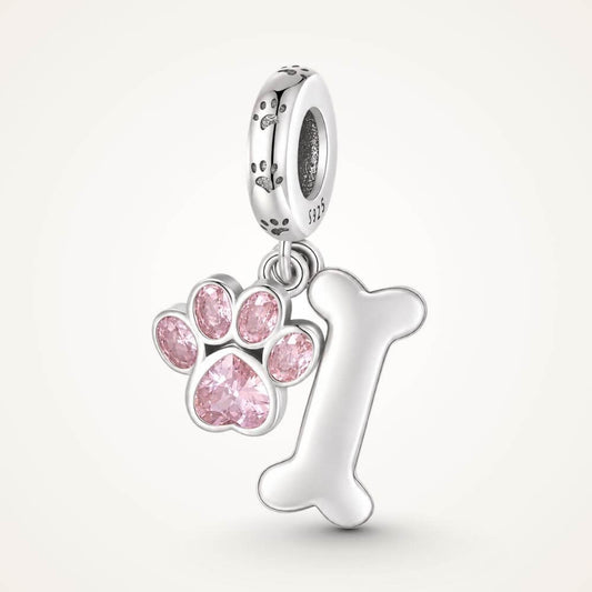 Sterling silver dog paw charm with pink crystal paw print, bone dangle, and playful pet-inspired details - ORÉYA