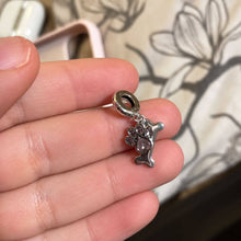 Sterling silver dog paw charm with pink crystal paw print, bone dangle, and playful pet-inspired details.