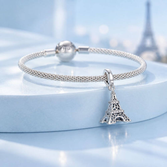 Sterling silver Eiffel Tower charm with sparkling crystal bands and detailed Paris landmark design.