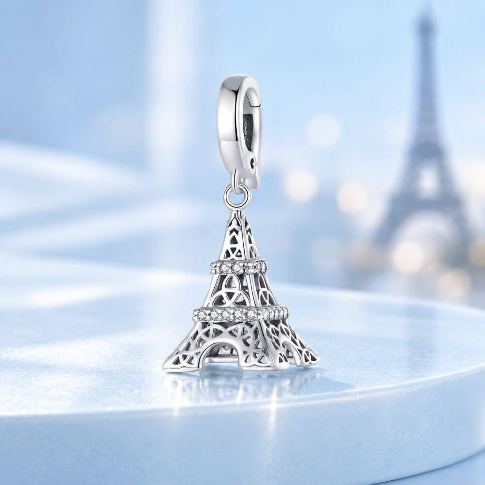 Sterling silver Eiffel Tower charm with sparkling crystal bands and detailed Paris landmark design.