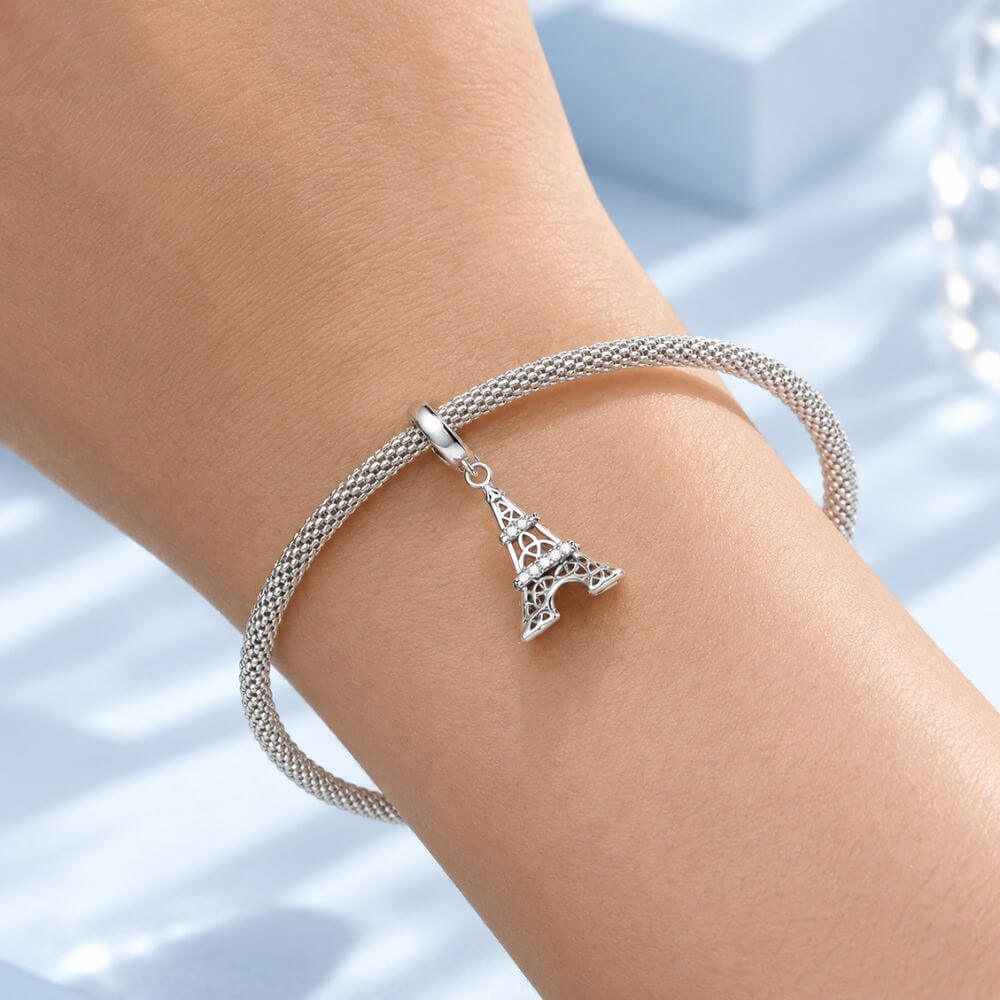 Sterling silver Eiffel Tower charm with sparkling crystal bands and detailed Paris landmark design.