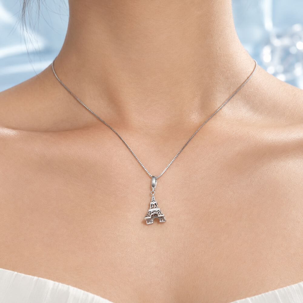 Sterling silver Eiffel Tower charm with sparkling crystal bands and detailed Paris landmark design.