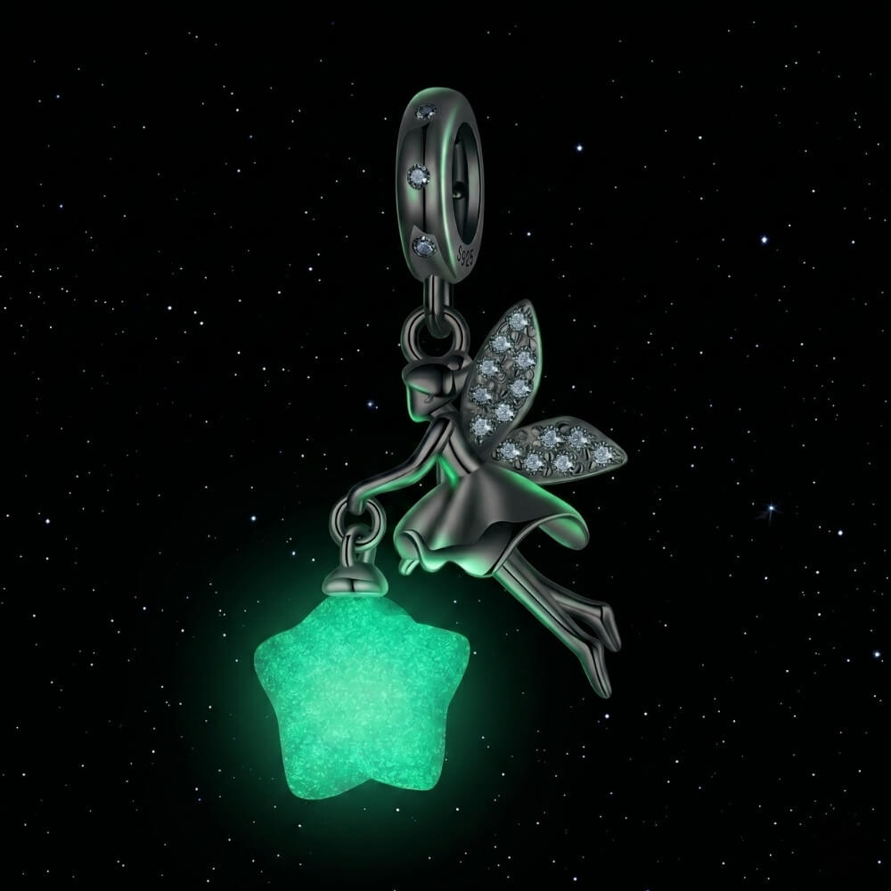 Sterling silver fairy charm holding glowing star with crystal wing details.