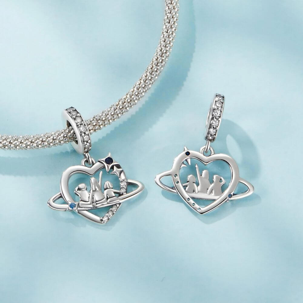 Sterling silver family heart charm with mother and children, blue crystals, stars, and orbit details.