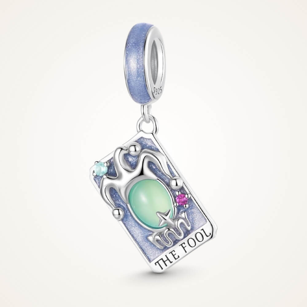 Sterling silver tarot charm with green crystal and blue enamel details.