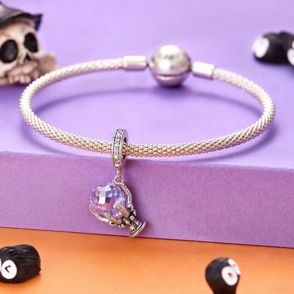 Sterling silver fortune teller charm with lavender crystal ball and skeletal hand.