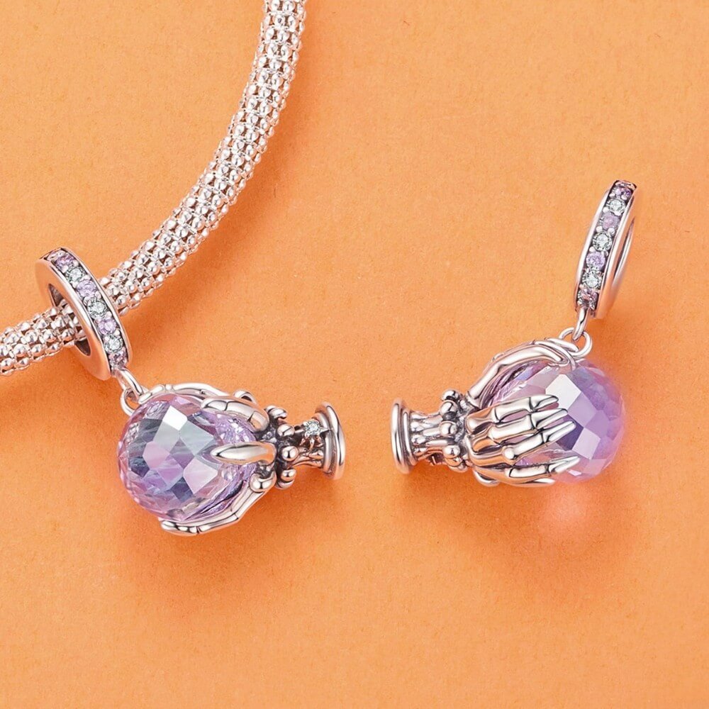 Sterling silver fortune teller charm with lavender crystal ball and skeletal hand.
