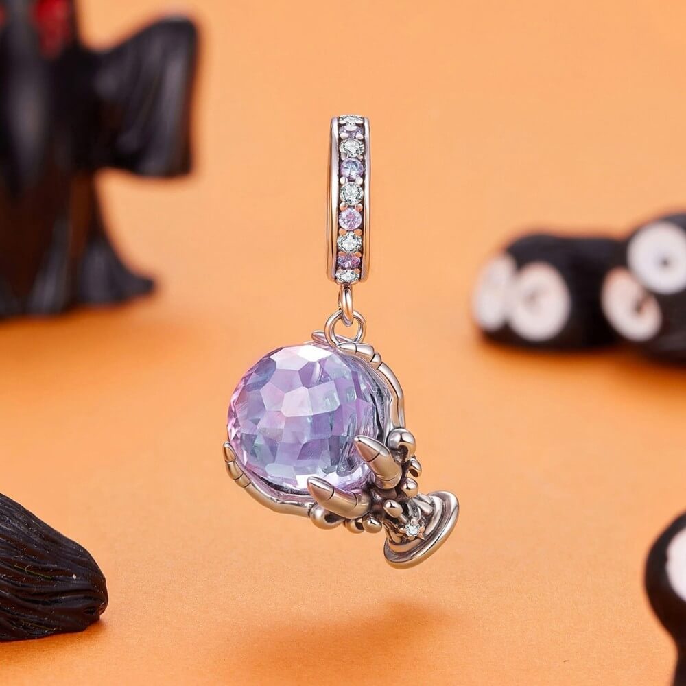 Sterling silver fortune teller charm with lavender crystal ball and skeletal hand.