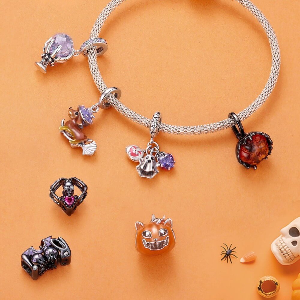 Sterling silver fortune teller charm with lavender crystal ball and skeletal hand.