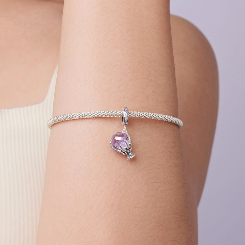 Sterling silver fortune teller charm with lavender crystal ball and skeletal hand.