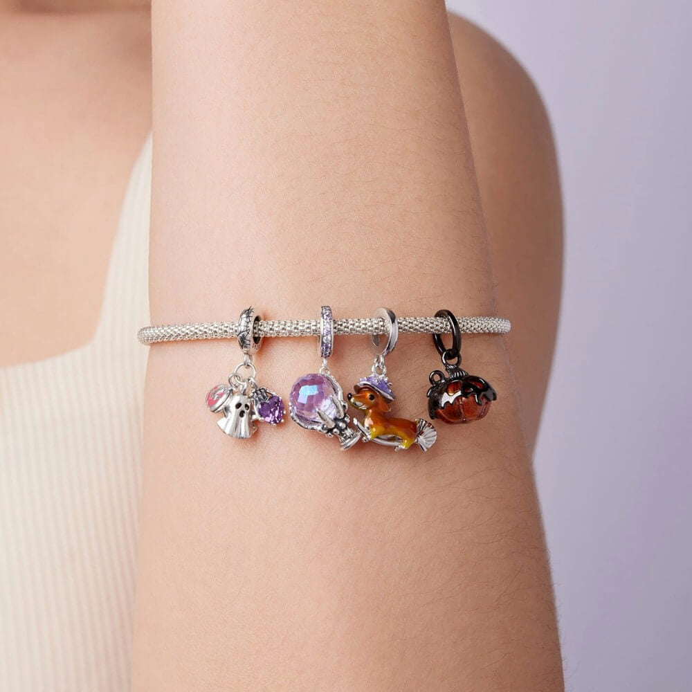 Sterling silver fortune teller charm with lavender crystal ball and skeletal hand.