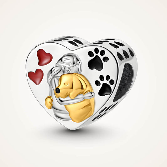 Sterling silver heart charm with gold-tone dog hugging a person, red hearts, and black paw prints – ORÉYA